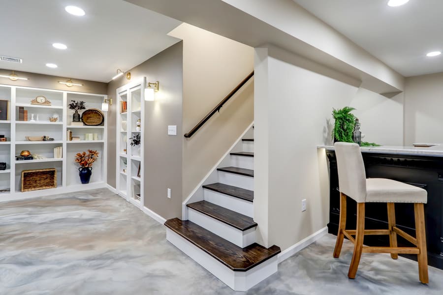 Elizabethtown Basement Remodel with built in shelving and wooden dual toned stairs