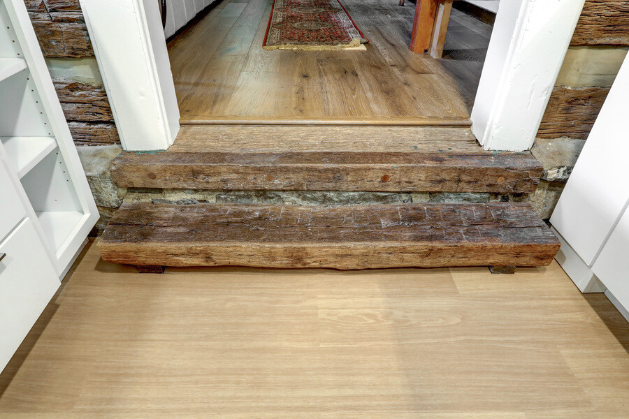 new flooring with original wooden step in Lancaster Historic Home Kitchen Remodel